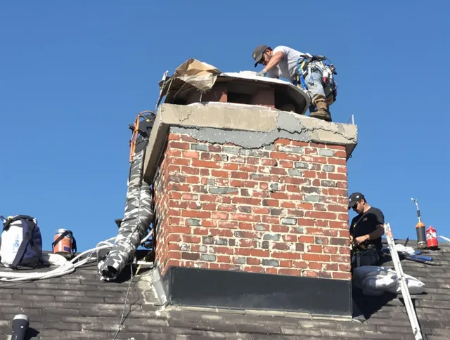 Holbrook Chimney Sweep installing a custom chimney crown in Holbrook, MA