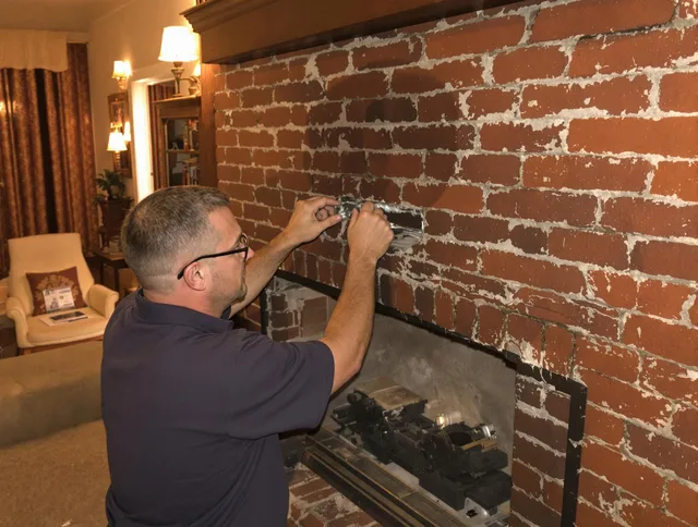 Holbrook Chimney Sweep expert fixing a fireplace in Holbrook, MA
